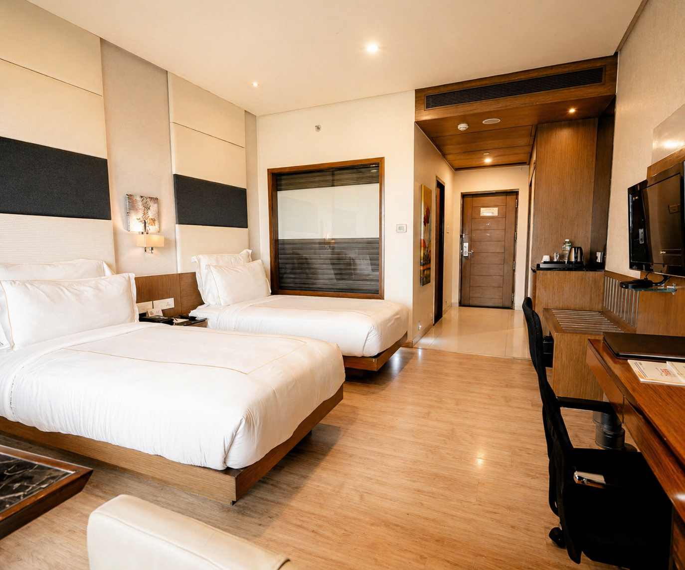 Deluxe Room with twin beds, TV and work desk at Narayani Heights